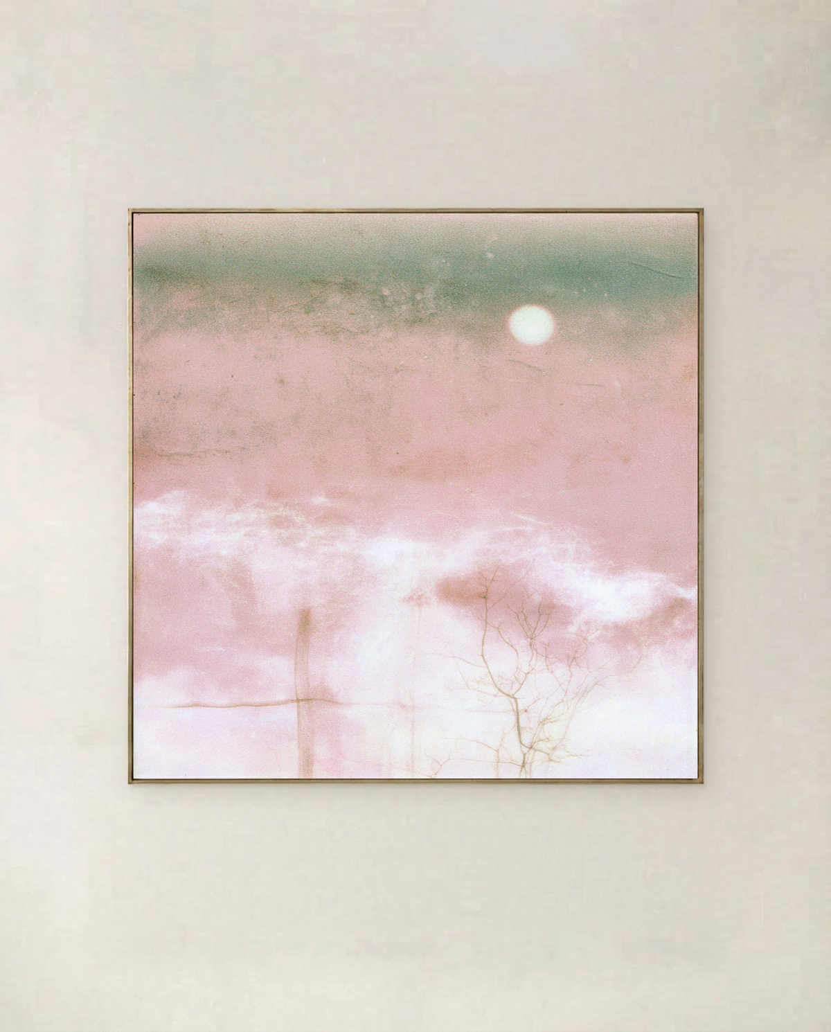 Pink Moon - white moon rising over a blush field with a sea-green horizon, shown in a thin gold frame on a pale wall